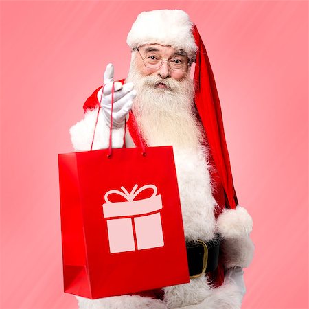 Santa claus distributing gifts to all on Christmas eve Stock Photo - Budget Royalty-Free & Subscription, Code: 400-08109283