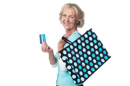 Happy senior shopper showing her credit card Stock Photo - Budget Royalty-Free & Subscription, Code: 400-08109638