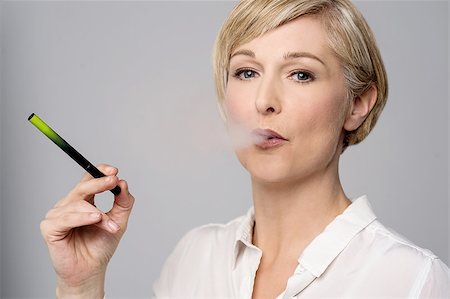 Woman smoking modern e-cigarette Stock Photo - Budget Royalty-Free & Subscription, Code: 400-08109676