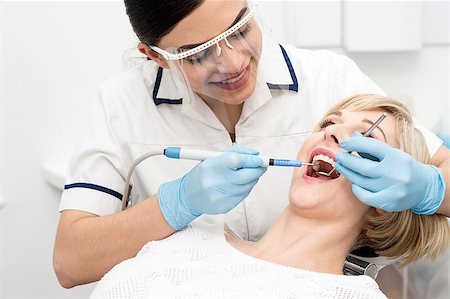 simsearch:400-08109752,k - Smiling female dentist procedure of teeth cleaning Stock Photo - Budget Royalty-Free & Subscription, Code: 400-08109726