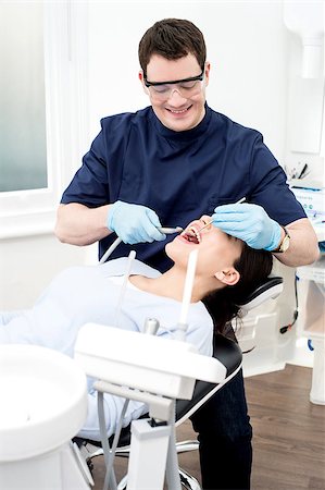 Female patient with dentist in a dental treatment Stock Photo - Budget Royalty-Free & Subscription, Code: 400-08109732