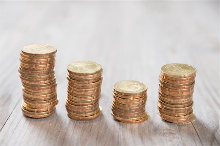 Coins stack in row on wooden background, financial concept. Focus on foreground with blur background. Stock Photo - Budget Royalty-Free & Subscription, Code: 400-08114037