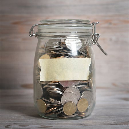 Coins in glass money jar with blank label, financial concept. Vintage wooden background with dramatic light. Stock Photo - Budget Royalty-Free & Subscription, Code: 400-08114040