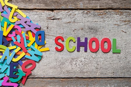 simsearch:400-07099266,k - The colorful words "SCHOOL" made with wooden letters next to a pile of other letters over old wooden board. Fotografie stock - Microstock e Abbonamento, Codice: 400-08114062