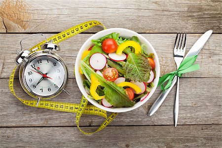 simsearch:400-06485512,k - Fresh healthy salad and measuring tape on wooden table. Healthy food Stock Photo - Budget Royalty-Free & Subscription, Code: 400-08114339
