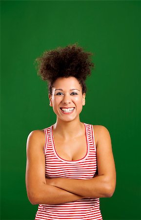 simsearch:400-06065810,k - Happy African woman with hands folded over a green background Foto de stock - Super Valor sin royalties y Suscripción, Código: 400-08114624