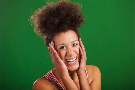 simsearch:400-06065810,k - Beautiful African woman laughing over a green background Foto de stock - Super Valor sin royalties y Suscripción, Código: 400-08114629