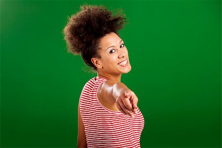 simsearch:400-06065810,k - Happy African woman pointing to something over a green background Foto de stock - Super Valor sin royalties y Suscripción, Código: 400-08114638