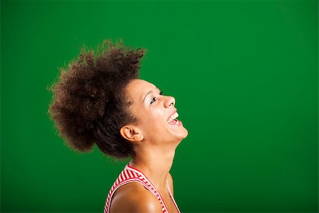 simsearch:400-06065810,k - Beautiful African woman laughing over a green background Foto de stock - Super Valor sin royalties y Suscripción, Código: 400-08114630