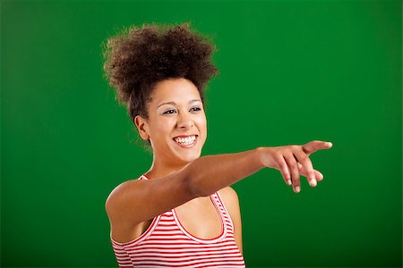 simsearch:400-06065810,k - Happy African woman pointing to something over a green background Foto de stock - Super Valor sin royalties y Suscripción, Código: 400-08114633
