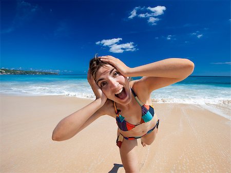 shooting the head with the hand - Beautiful and happy young woman  enjoying the summer on a tropical beach Stock Photo - Budget Royalty-Free & Subscription, Code: 400-08114661