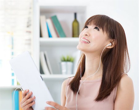 Portrait of attractive Asian girl listening to music and dancing with the beats. Young woman indoors living lifestyle at home. Stock Photo - Budget Royalty-Free & Subscription, Code: 400-08114853