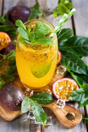 passiflora - Homemade lemonade with passionfruit, mint leaves and ice cubes on old wooden background Stock Photo - Budget Royalty-Free & Subscription, Code: 400-08114908