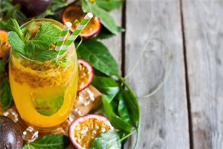 passiflora - Homemade lemonade with passionfruit, mint leaves and ice cubes on old wooden background. Copy space background. Photographie de stock - Aubaine LD & Abonnement, Code: 400-08114909
