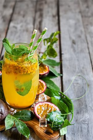 passiflora - Homemade lemonade with passionfruit, mint leaves and ice cubes on old wooden background. Copy space background. Photographie de stock - Aubaine LD & Abonnement, Code: 400-08114910