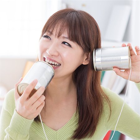 simsearch:400-05375851,k - Asian girl using old technology, talk and listen to communication cans. Young woman indoors living lifestyle at home. Foto de stock - Super Valor sin royalties y Suscripción, Código: 400-08115327