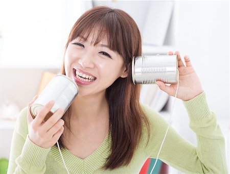 simsearch:400-05375851,k - Happy Asian girl using old technology, talk and listen to communication cans. Young woman indoors living lifestyle at home. Foto de stock - Super Valor sin royalties y Suscripción, Código: 400-08115328