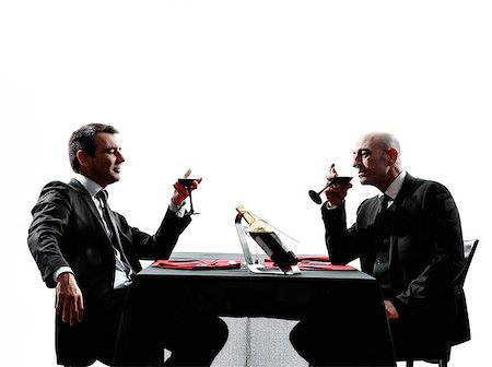 two businessmen dinning in silhouettes on white background Stock Photo - Budget Royalty-Free & Subscription, Code: 400-08115554