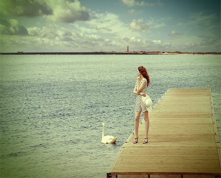 elegant dock - romantic shot of a girl standing on wooden pier , in the lake with a white swan near her , summer day .vintage color effect Stock Photo - Budget Royalty-Free & Subscription, Code: 400-08116006