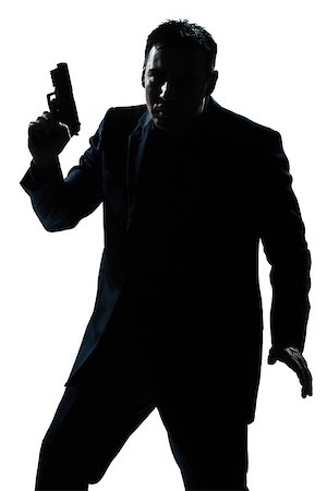 simsearch:400-07097770,k - one  spy criminal policeman detective man holding gun portrait silhouette in studio isolated white background Photographie de stock - Aubaine LD & Abonnement, Code: 400-08116059