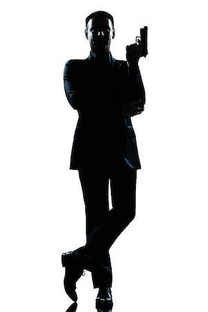 police detective standing - one  secret agent in a james bond posture holding gun full length silhouette in studio isolated white background Stock Photo - Budget Royalty-Free & Subscription, Code: 400-08116051
