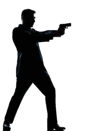 simsearch:400-07097770,k - one  spy criminal policeman detective man aiming shooting gun full length silhouette in studio isolated white background Photographie de stock - Aubaine LD & Abonnement, Code: 400-08116052