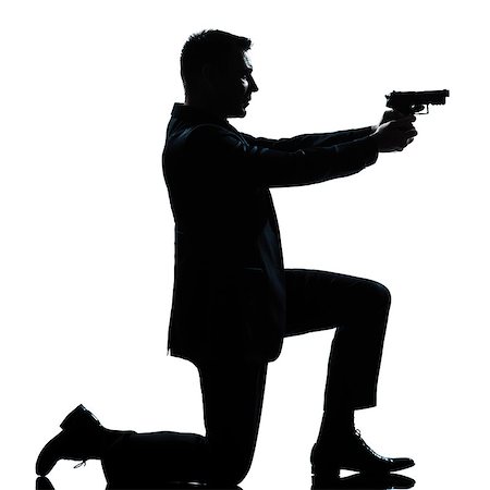 simsearch:400-07097770,k - one  spy criminal policeman detective man aiming shooting gun full length silhouette in studio isolated white background Photographie de stock - Aubaine LD & Abonnement, Code: 400-08116053