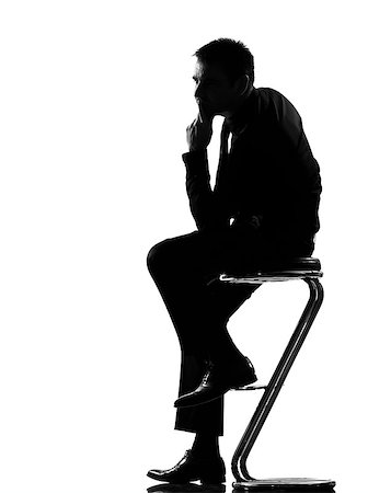 silhouette  business man thinking pensive sititting on foot stool full length on studio isolated white background Stock Photo - Budget Royalty-Free & Subscription, Code: 400-08116094