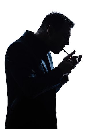 one  man portrait smoking lighting cigarette silhouette in studio isolated white background Stock Photo - Budget Royalty-Free & Subscription, Code: 400-08116090