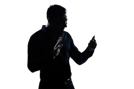 one  man salute gesture telephone videophone portrait silhouette in studio isolated white background Stock Photo - Budget Royalty-Free & Subscription, Code: 400-08116146