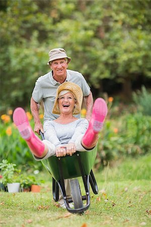simsearch:400-07927044,k - Happy senior couple playing with a wheelbarrow in a sunny day Stock Photo - Budget Royalty-Free & Subscription, Code: 400-08116304
