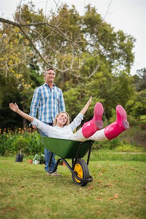 simsearch:400-07927044,k - Happy couple playing with a wheelbarrow on a sunny day Stock Photo - Budget Royalty-Free & Subscription, Code: 400-08116309