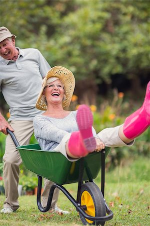 simsearch:400-07927044,k - Happy senior couple playing with a wheelbarrow in a sunny day Stock Photo - Budget Royalty-Free & Subscription, Code: 400-08116303