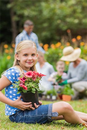 simsearch:400-08116305,k - Young girl sitting with flower pot on a sunny day Stock Photo - Budget Royalty-Free & Subscription, Code: 400-08116316