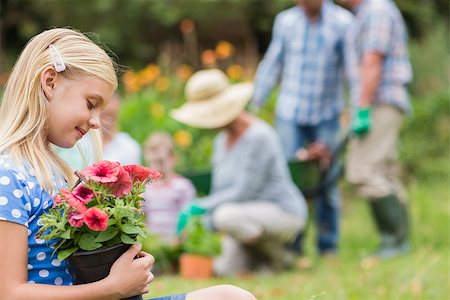 simsearch:400-08116305,k - Young girl sitting with flower pot on a sunny day Stock Photo - Budget Royalty-Free & Subscription, Code: 400-08116319