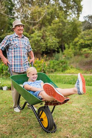 simsearch:400-07927044,k - Happy grandfather and his granddaughter with a wheelbarrow in a sunny day Stock Photo - Budget Royalty-Free & Subscription, Code: 400-08116311