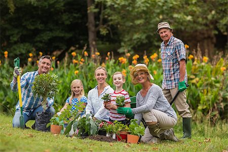 simsearch:400-08116305,k - Happy family gardening on a sunny day Stock Photo - Budget Royalty-Free & Subscription, Code: 400-08116313