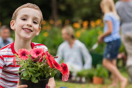 simsearch:400-08116305,k - Young boy sitting with flower pot on sunny day Stock Photo - Budget Royalty-Free & Subscription, Code: 400-08116320