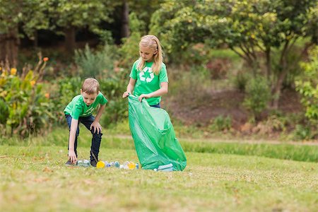 Happy siblings collecting rubbish on a sunny day Stock Photo - Budget Royalty-Free & Subscription, Code: 400-08116330