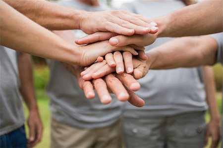 Happy volunteer family putting their hands together on a sunny day Photographie de stock - Aubaine LD & Abonnement, Code: 400-08116367