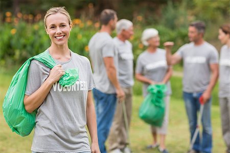 simsearch:400-08116305,k - Happy volunteer collecting rubbish on a sunny day Stock Photo - Budget Royalty-Free & Subscription, Code: 400-08116363