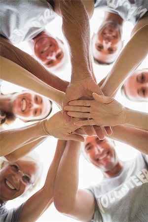 simsearch:400-08116305,k - Happy volunteer family putting their hands together on a sunny day Stock Photo - Budget Royalty-Free & Subscription, Code: 400-08116370