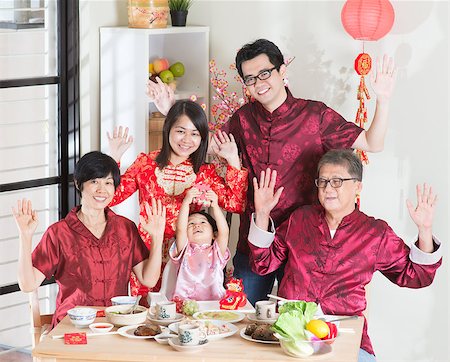 Chinese New Year, reunion dinner. Happy Asian Chinese multi generation family with red cheongsam dining at home. Stock Photo - Budget Royalty-Free & Subscription, Code: 400-08116774