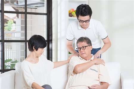 elderly chinese patient - Asian old man shoulder pain, sitting on sofa with wife, son massaging father shoulder. Chinese family, senior retiree indoors living lifestyle at home. Stock Photo - Budget Royalty-Free & Subscription, Code: 400-08116790