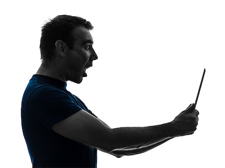 simsearch:400-08317008,k - one  man holding digital tablet surprised in silhouette on white background Stockbilder - Microstock & Abonnement, Bildnummer: 400-08110679