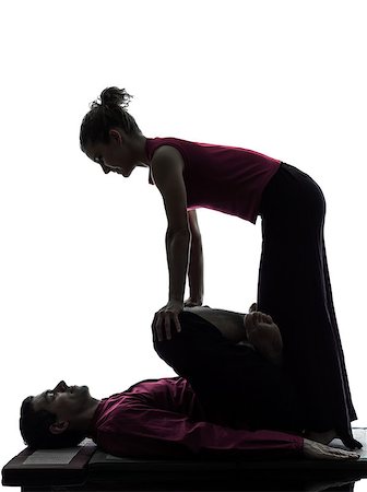 full body massage - one man and woman performing thai massage in silhouette studio on white background Stock Photo - Budget Royalty-Free & Subscription, Code: 400-08110681