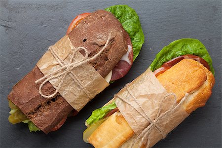 simsearch:400-07099478,k - Two sandwiches with salad, ham, cheese and tomatoes on stone table Stock Photo - Budget Royalty-Free & Subscription, Code: 400-08110704