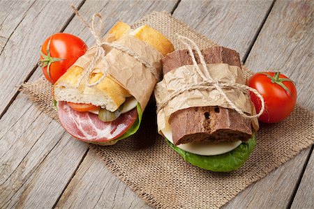 simsearch:400-07099478,k - Two sandwiches with salad, ham, cheese and tomatoes on wooden table Stock Photo - Budget Royalty-Free & Subscription, Code: 400-08110701