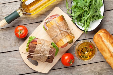simsearch:400-07099478,k - Sandwiches and white wine on wooden table. Top view Stock Photo - Budget Royalty-Free & Subscription, Code: 400-08110703
