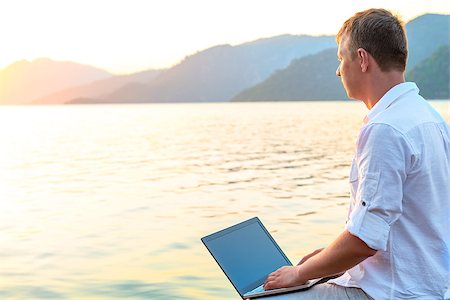 free man with a laptop admires dawn Stock Photo - Budget Royalty-Free & Subscription, Code: 400-08111295